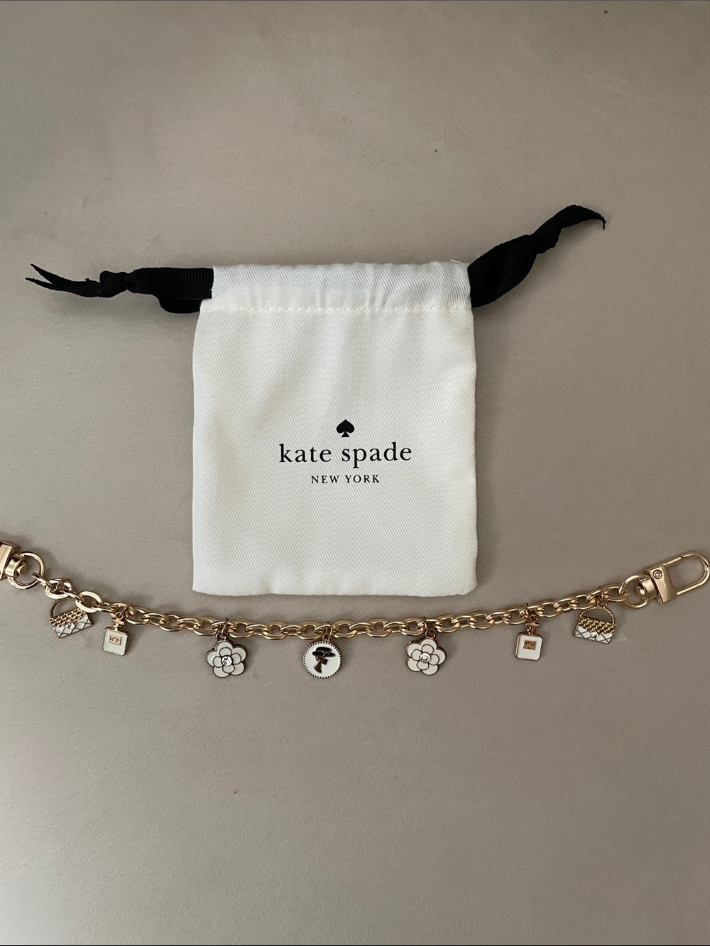 kate spade Gold-Tone Charm Bracelet with White Enamel Accents